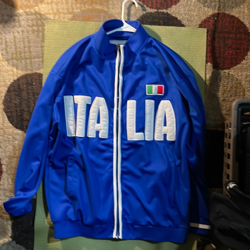 Slightly worn. Full zip up athletic jacket.